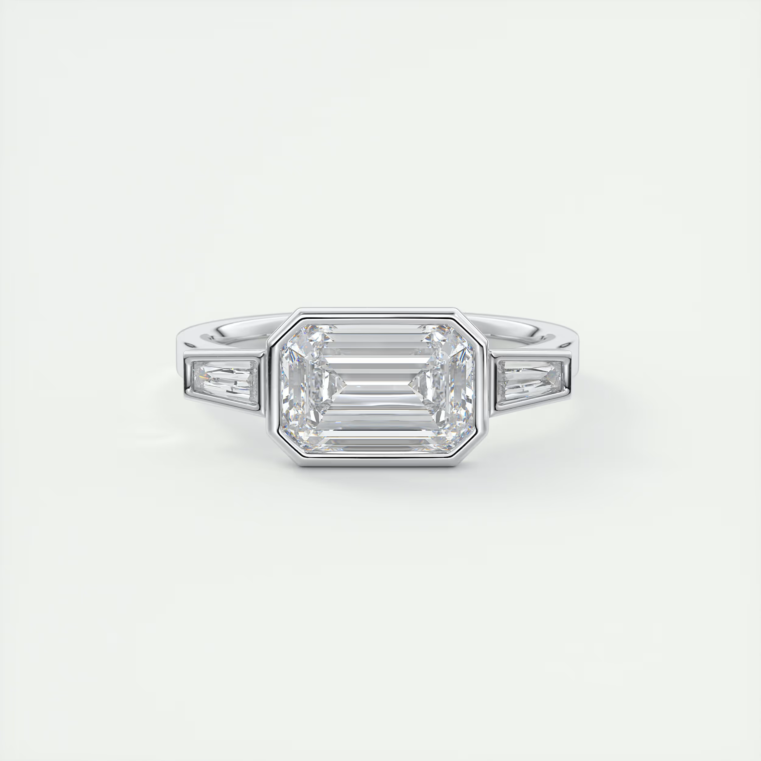 Elevated 2 Carat Emerald & Tapered Baguette Three-Stone Bezel Set Engagement Ring