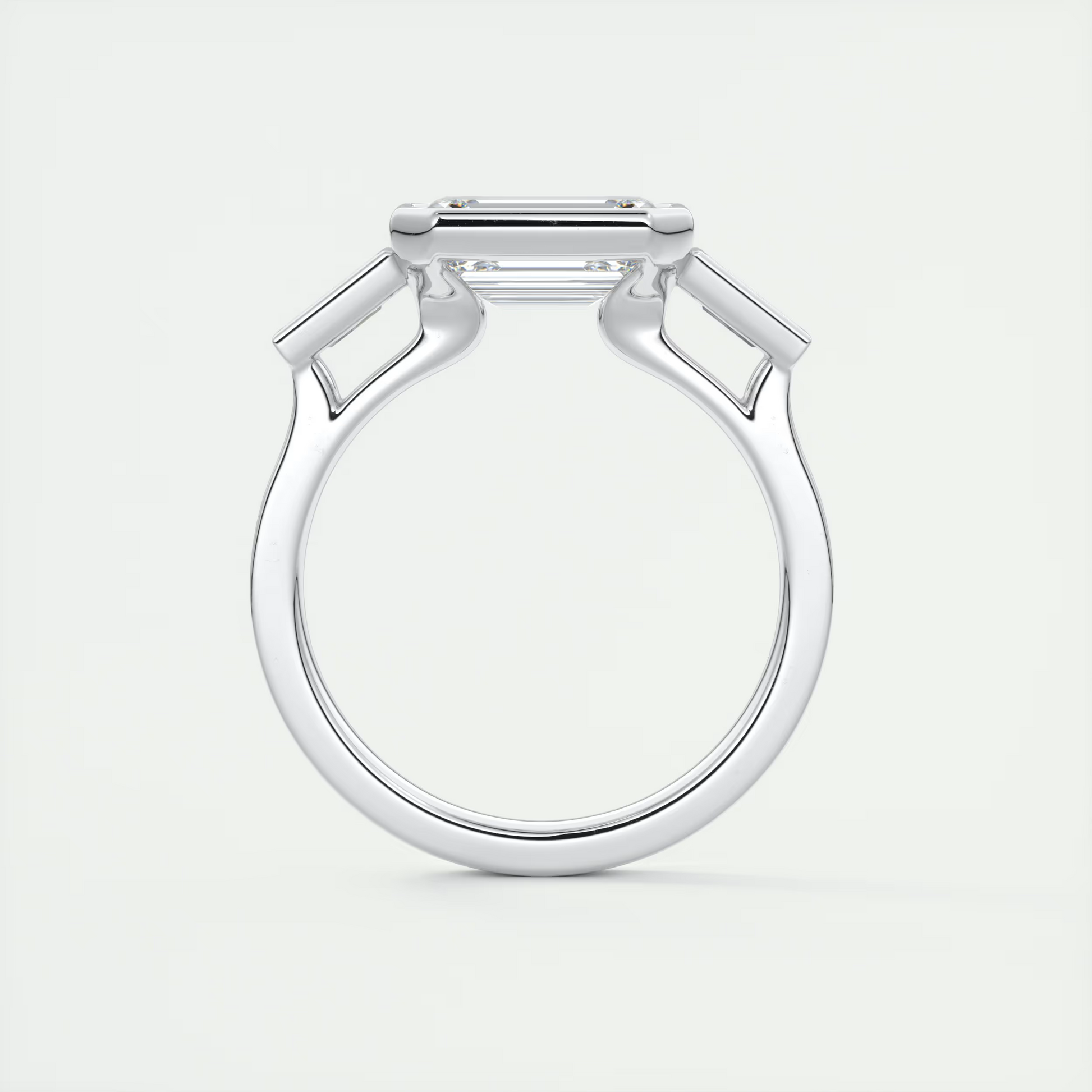 Elevated 2 Carat Emerald & Tapered Baguette Three-Stone Bezel Set Engagement Ring