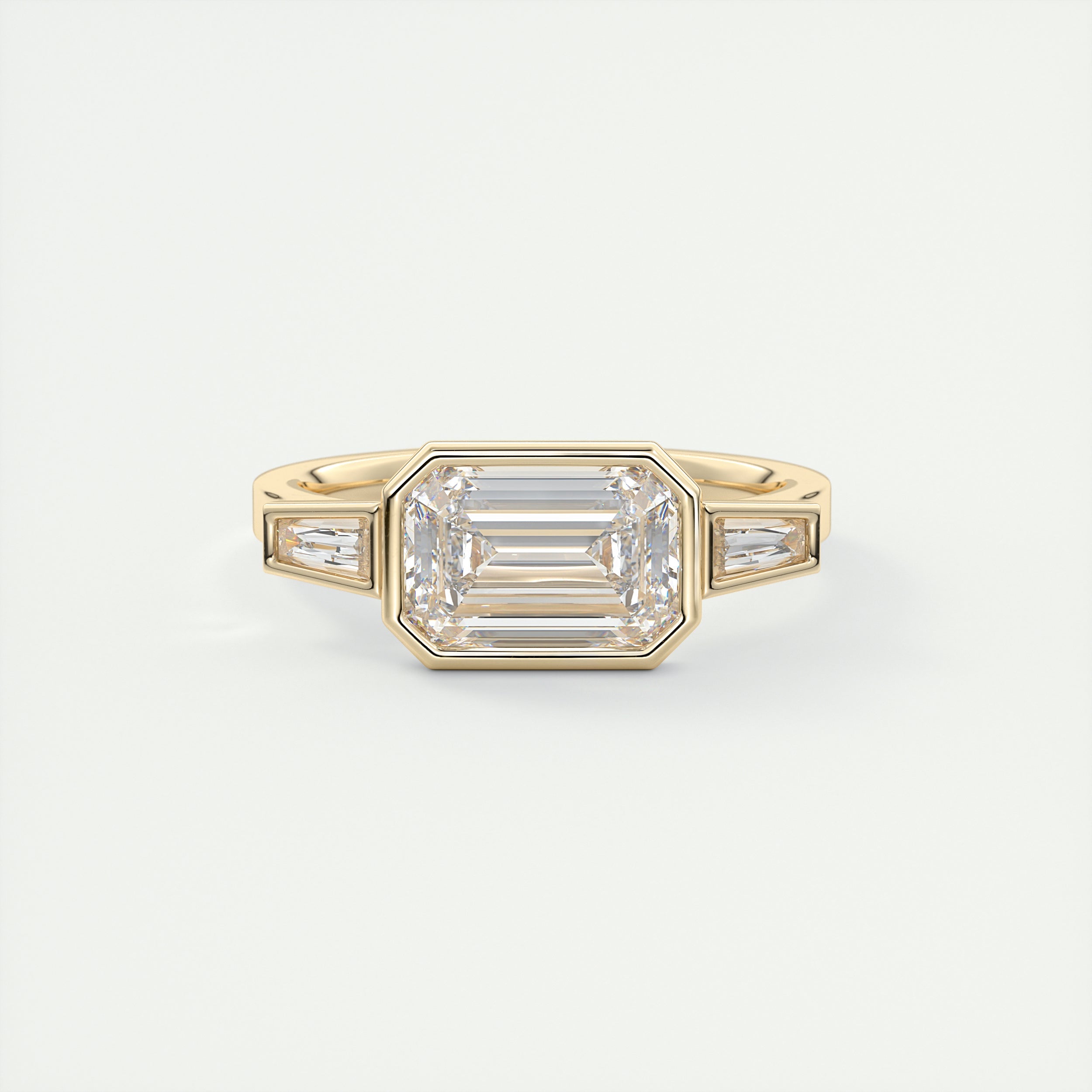 Elevated 2 Carat Emerald & Tapered Baguette Three-Stone Bezel Set Engagement Ring